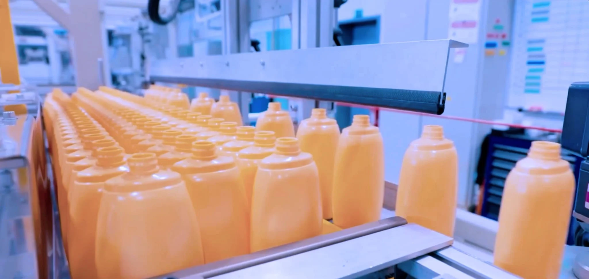 Bottles moving along a production line at Axium Packaging