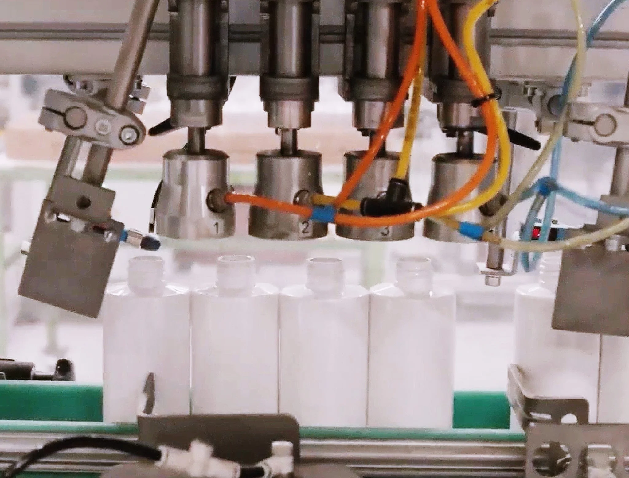 Bottles being filled on a production line at Axium Packaging