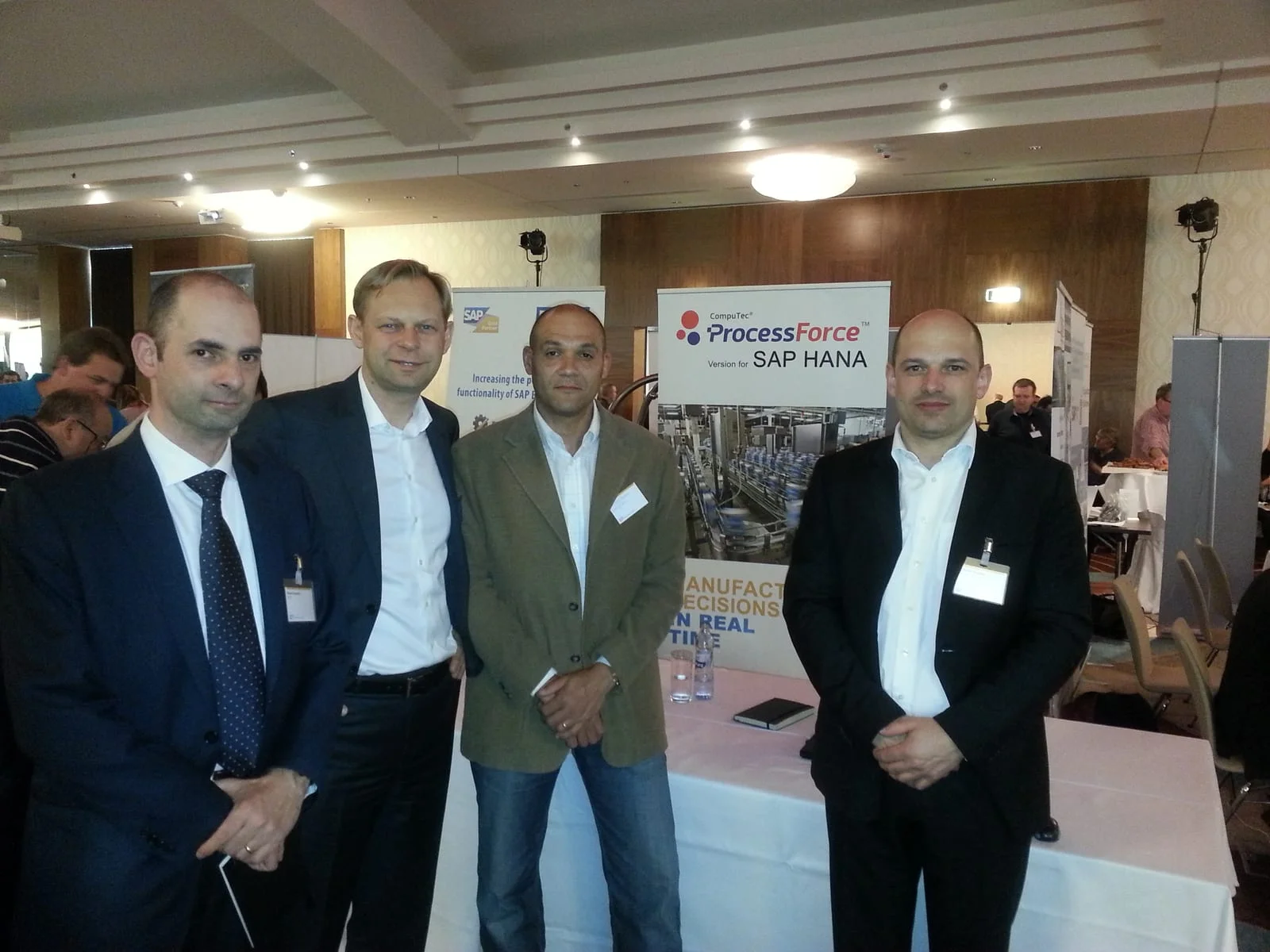 Four men at the CompuTec ProcessForce version for SAP HANA stand at the SAP Business One HANA TechSummit