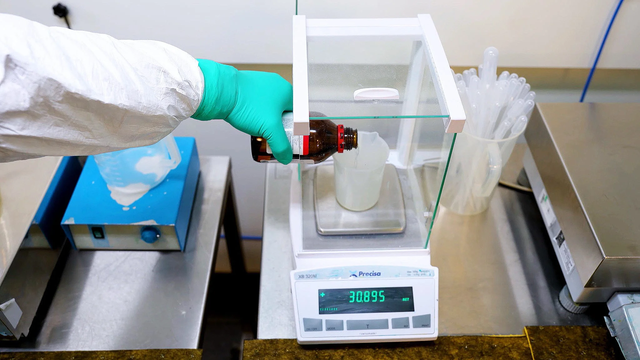 A Contamac technician weighing material on a precision scale, tracked in CompuTec PDC