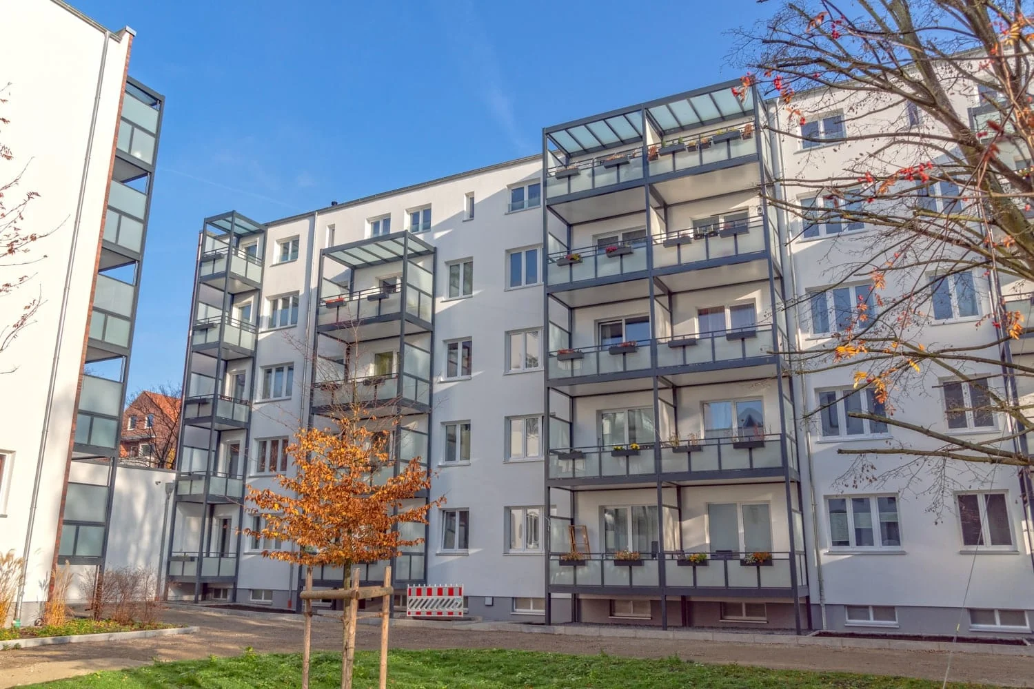 An apartment building fitted with Copal's aluminum balcony enclosures