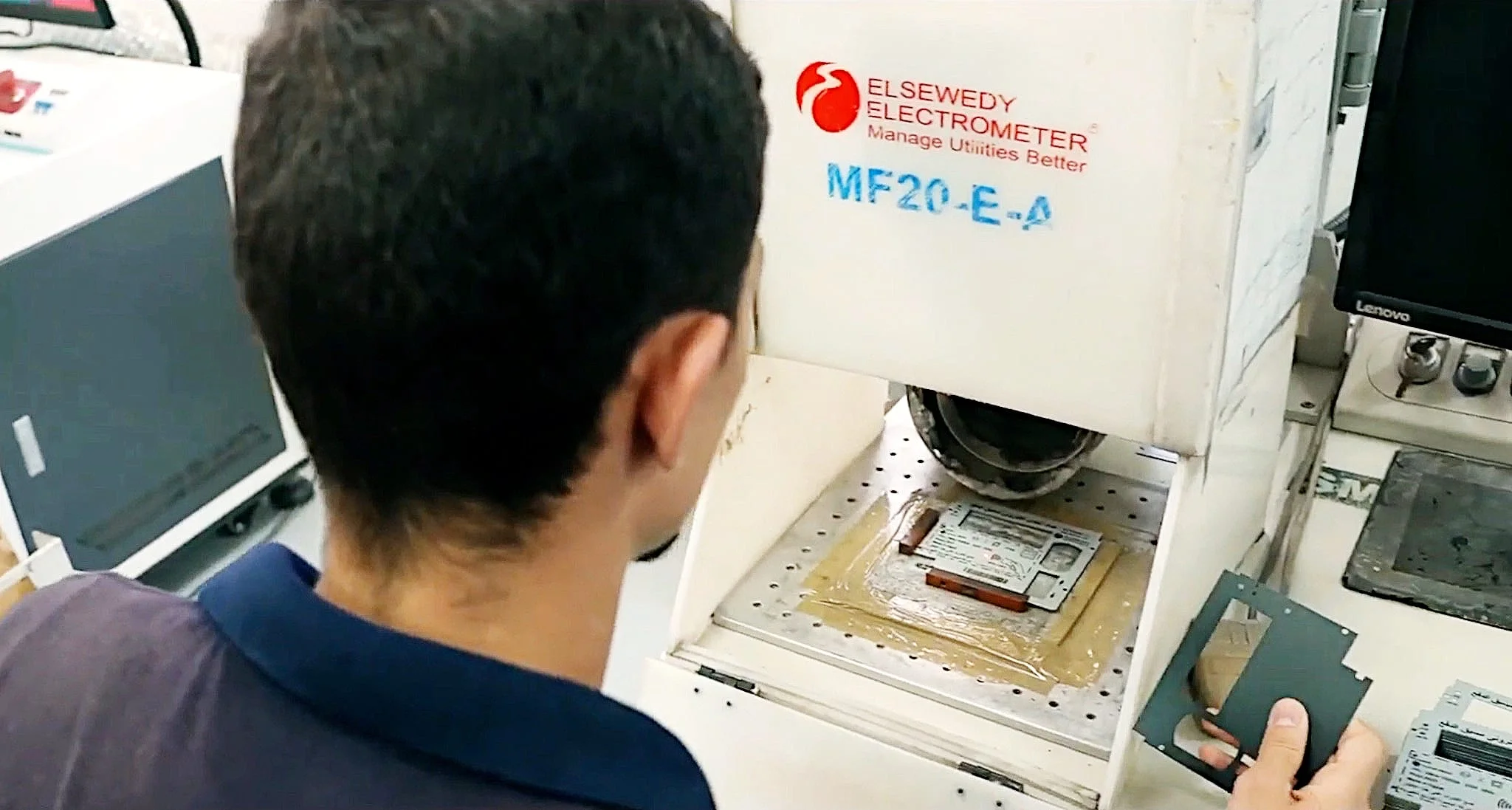 An El Sewedy Electrometer technician operating a laser marking machine
