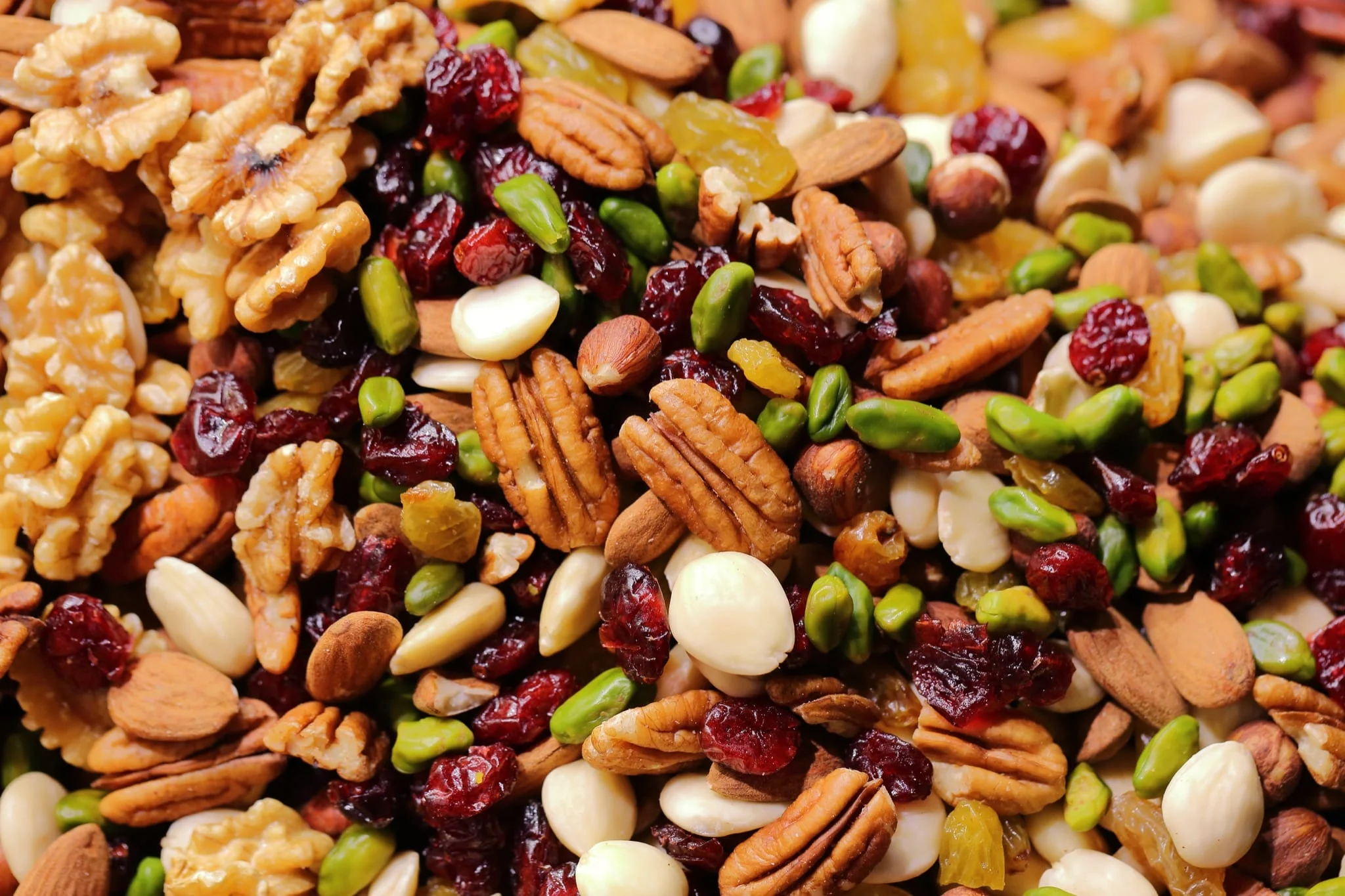 A mix of dried fruit and nuts, including walnuts, cranberries, and pistachios