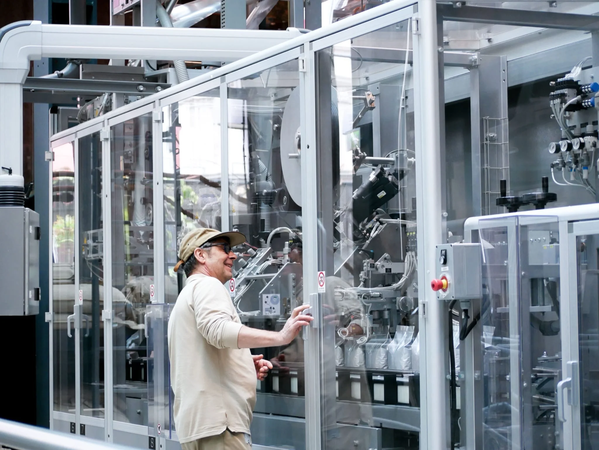 A worker monitoring an automated packaging line