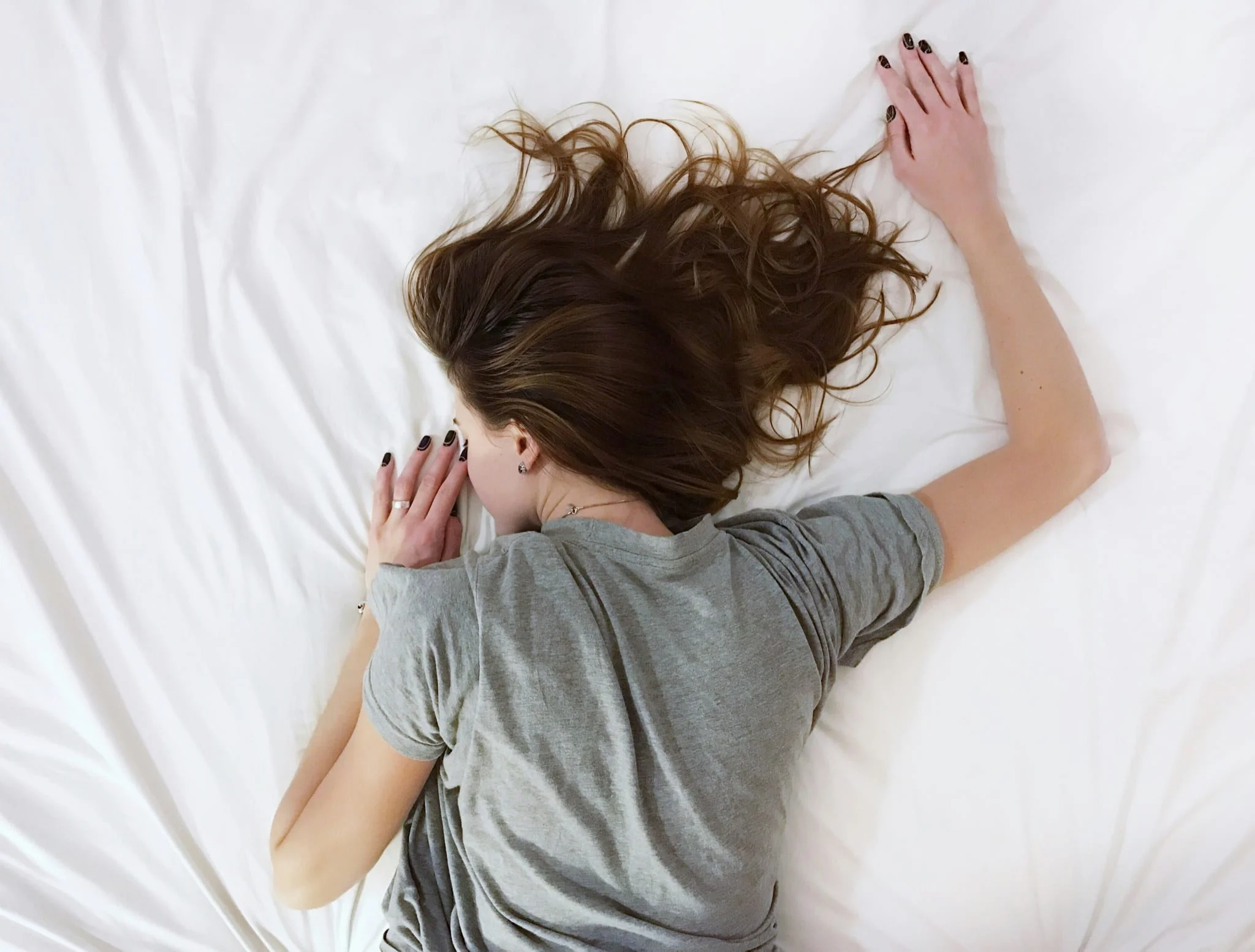 A person sleeping peacefully on a mattress
