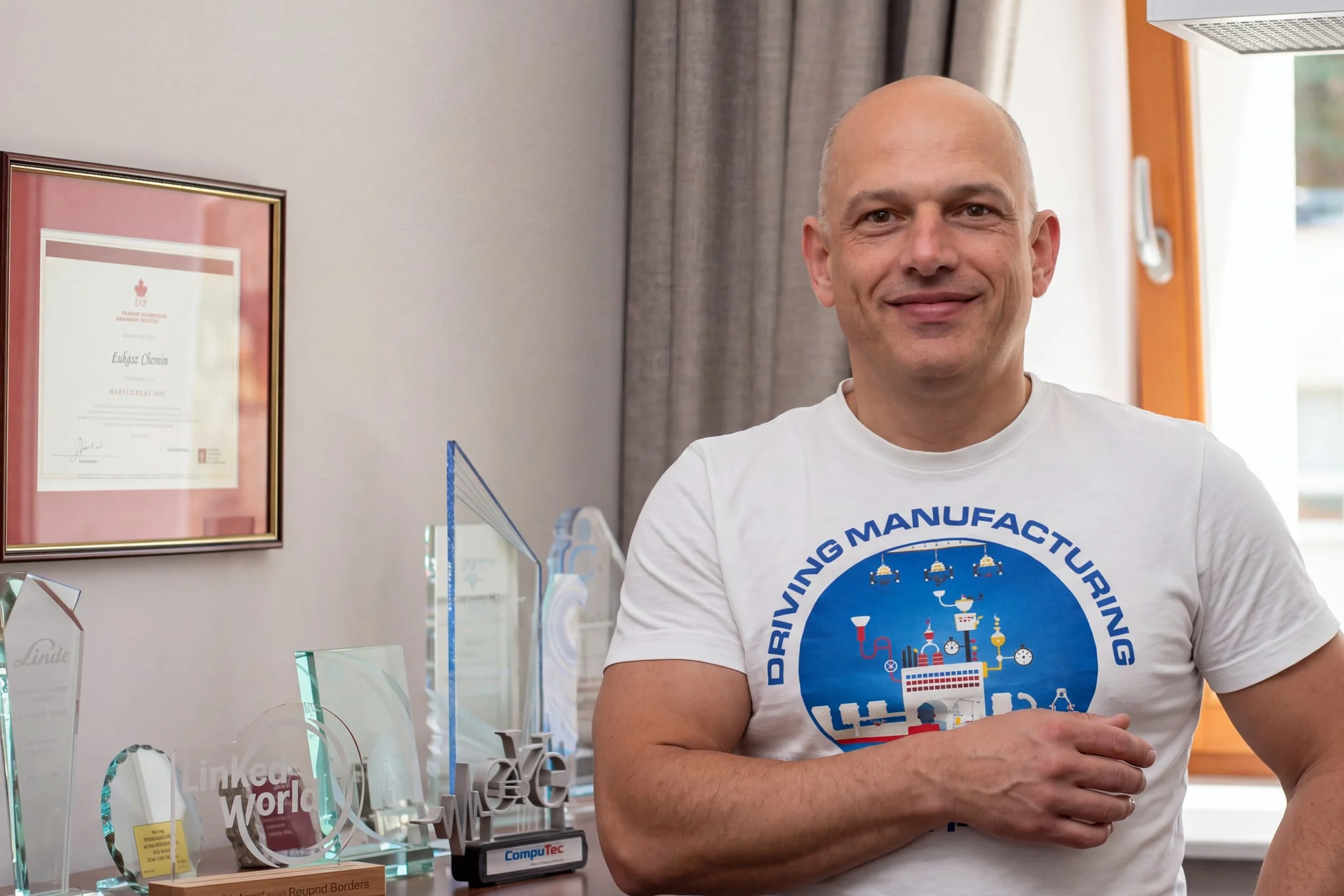Lukasz Chomin, CompuTec's CEO and Founder, with the company's industry awards.