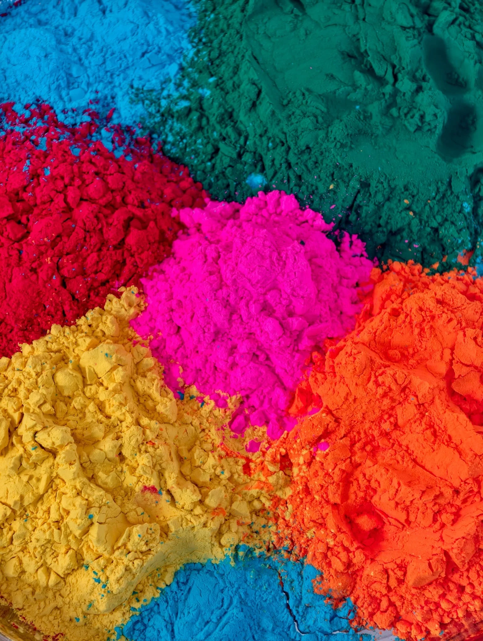 Piles of vividly colored pigment powder