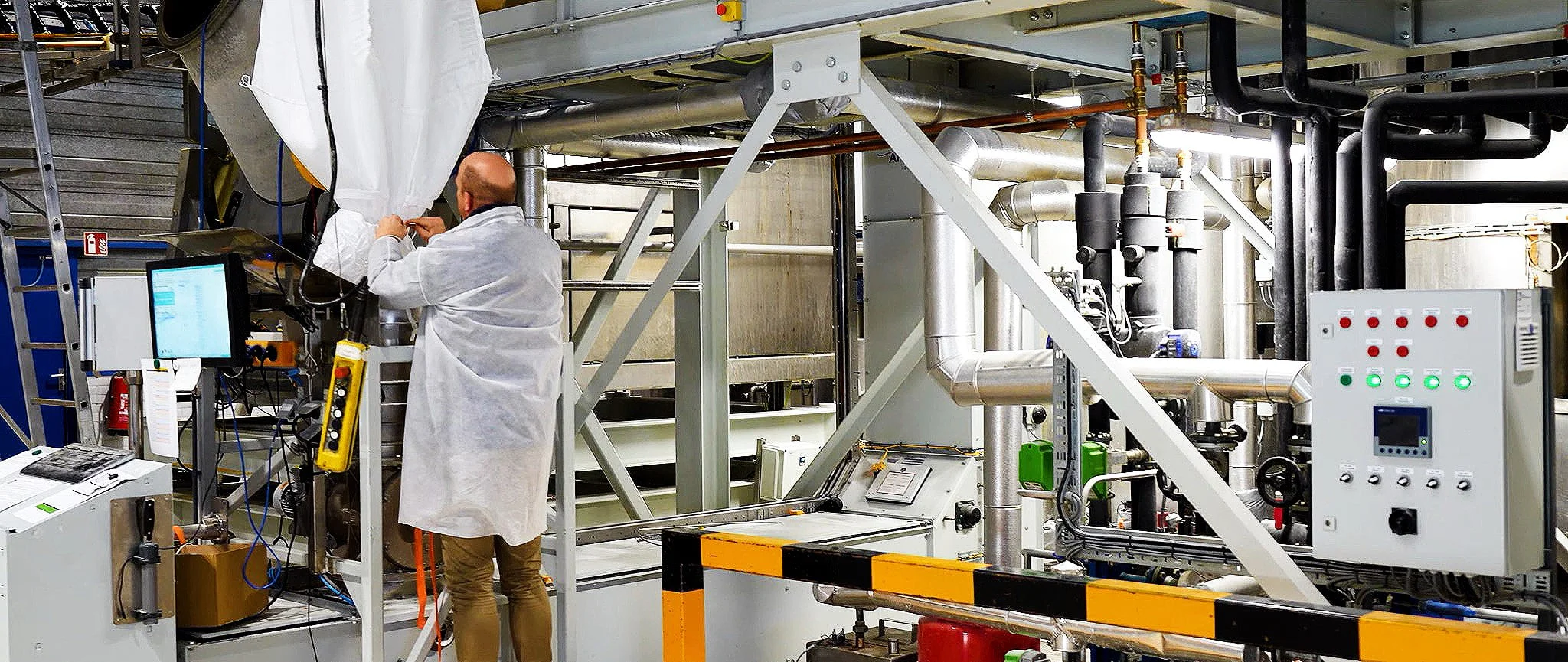 A Palital Feed Additives employee loading raw material into the production line