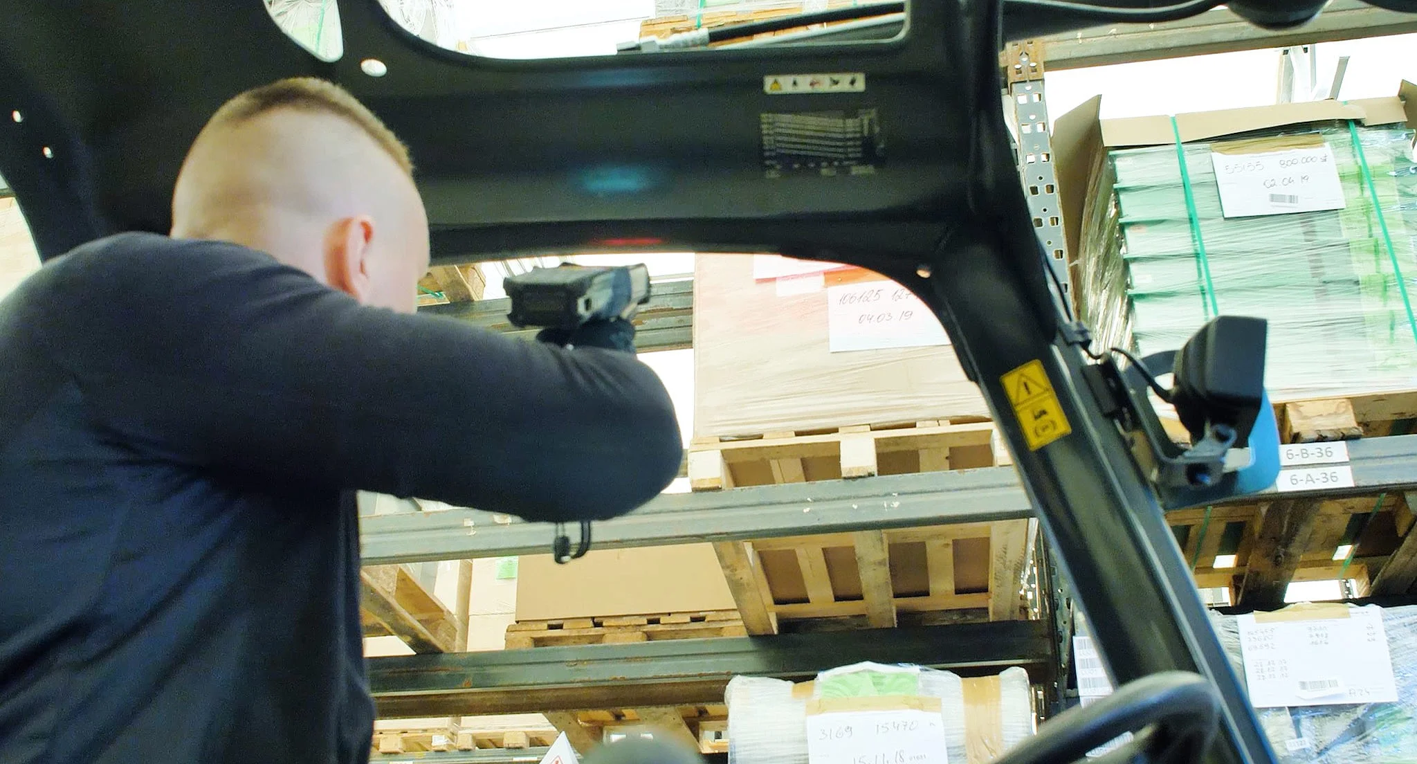 A Schnug Logistic Group employee scanning a pallet label from a forklift