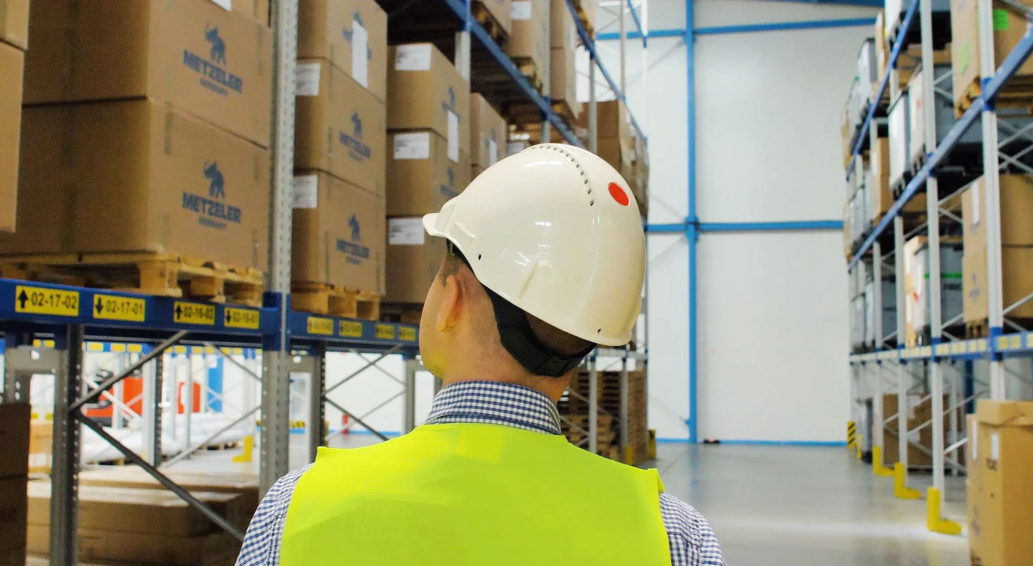 A Schnug Logistic Group employee reviewing pallets in warehouse racking