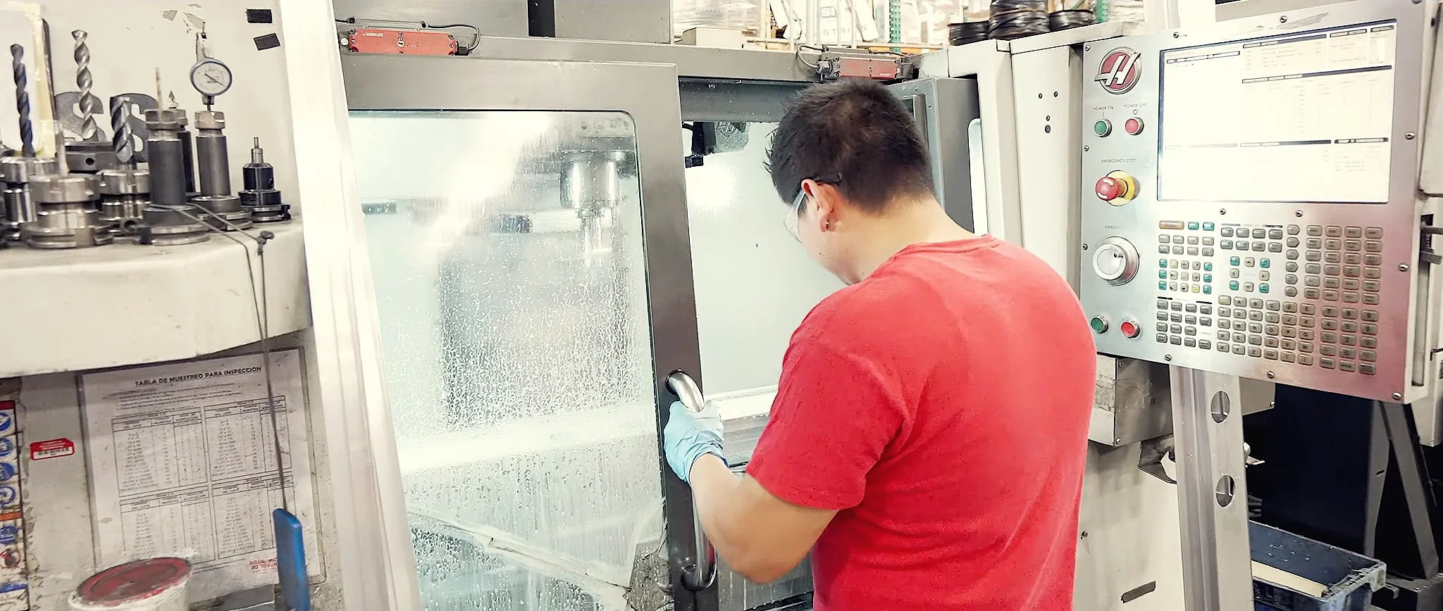 A Trans-Continental Manufacturing technician operating a CNC machine