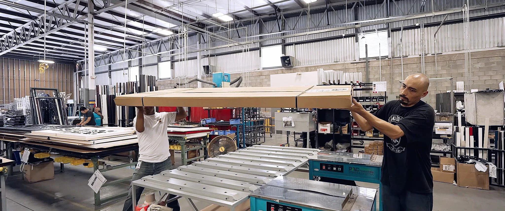 Trans-Continental Manufacturing employees preparing a finished panel for shipping
